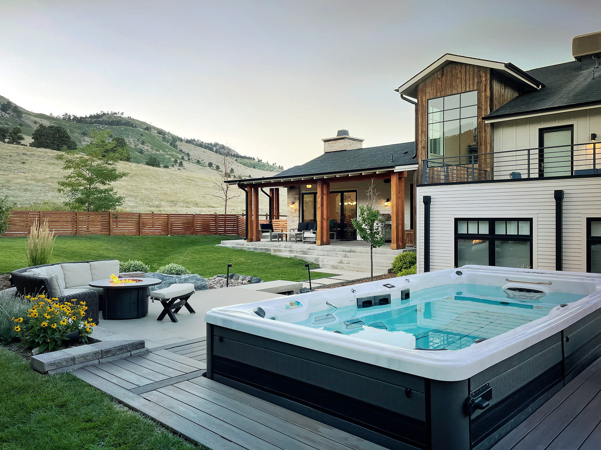 H2X Trainer swim spa in a backyard oasis