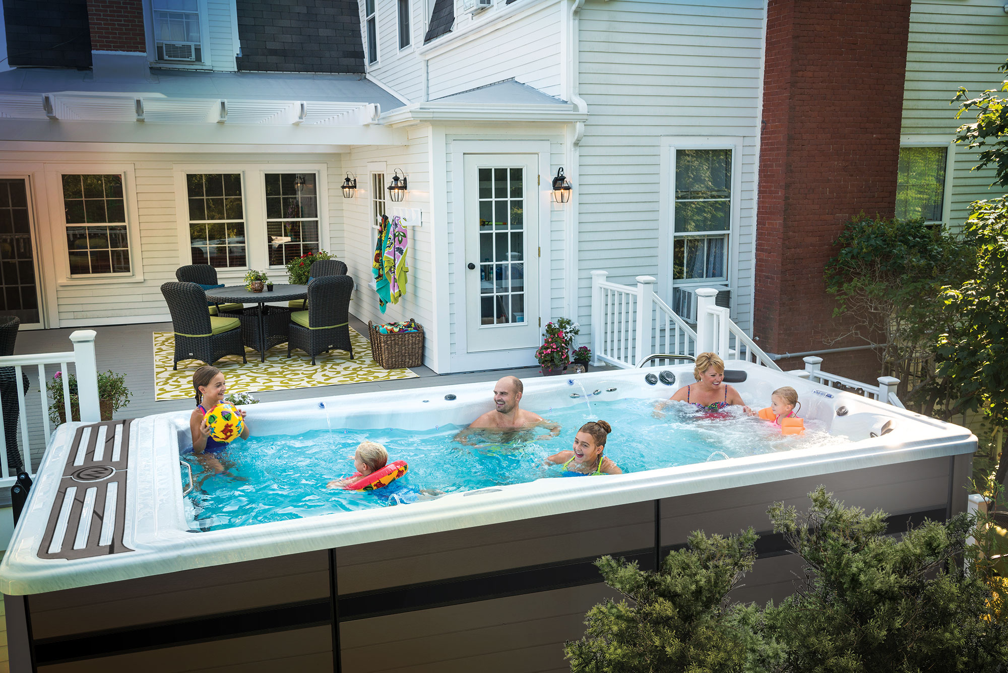 Family enjoying a Michael Phelps Signature swim spa