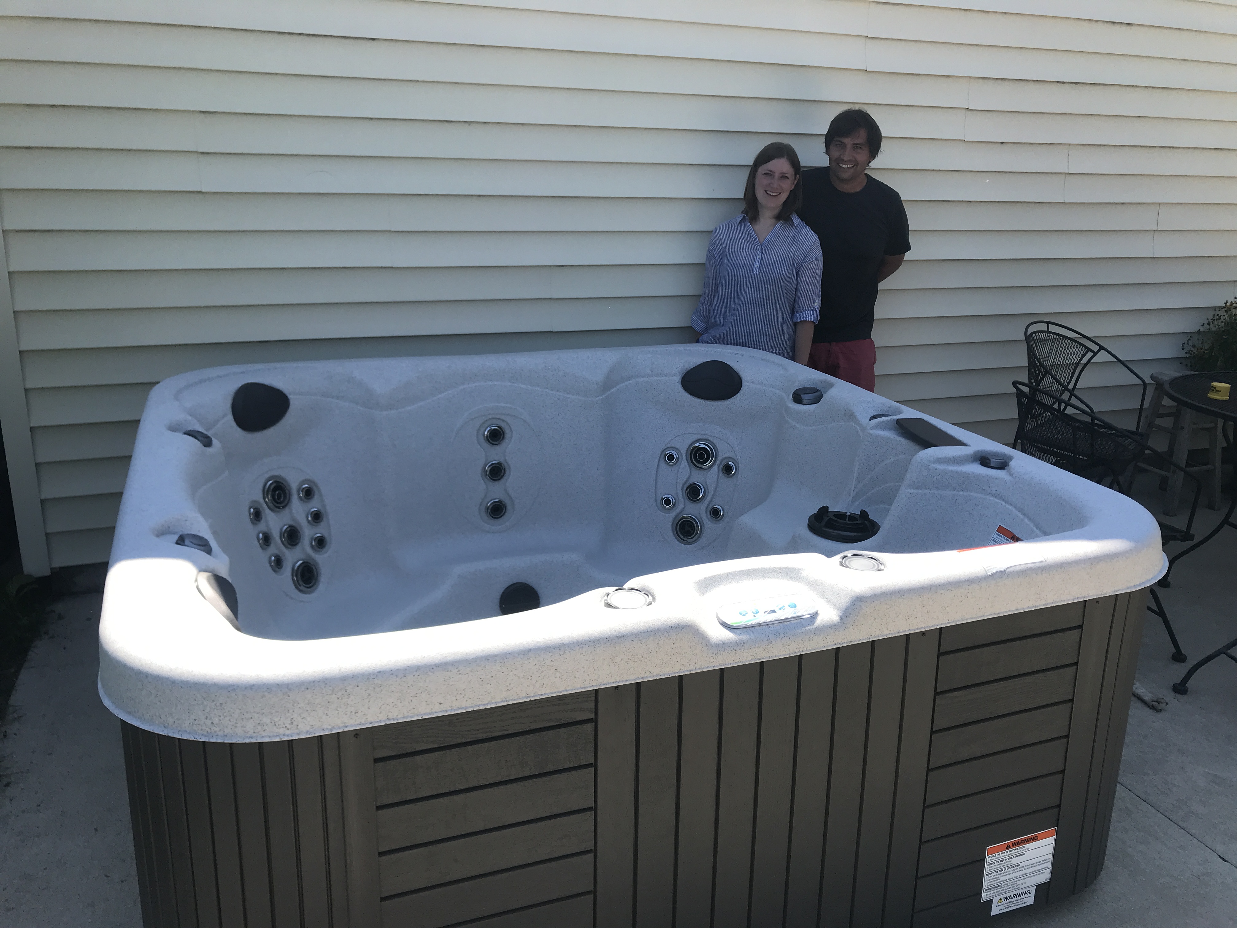 Happy customers with their new Clarity Series hot tub